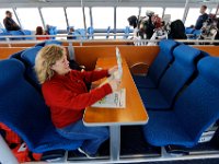 1008280152 ma nb NantucketFerry  Lauren Fontaine, who was a bartender aboard the old Schamonchi Ferry to Marthas Vineyard, settles down for the maiden voyage of the Seastreak Whaling City Express ferry service from New Bedford to Nantucket.   PETER PEREIRA/THE STANDARD-TIMES/SCMG : ferry, waterfront, voyage, trip, harbor